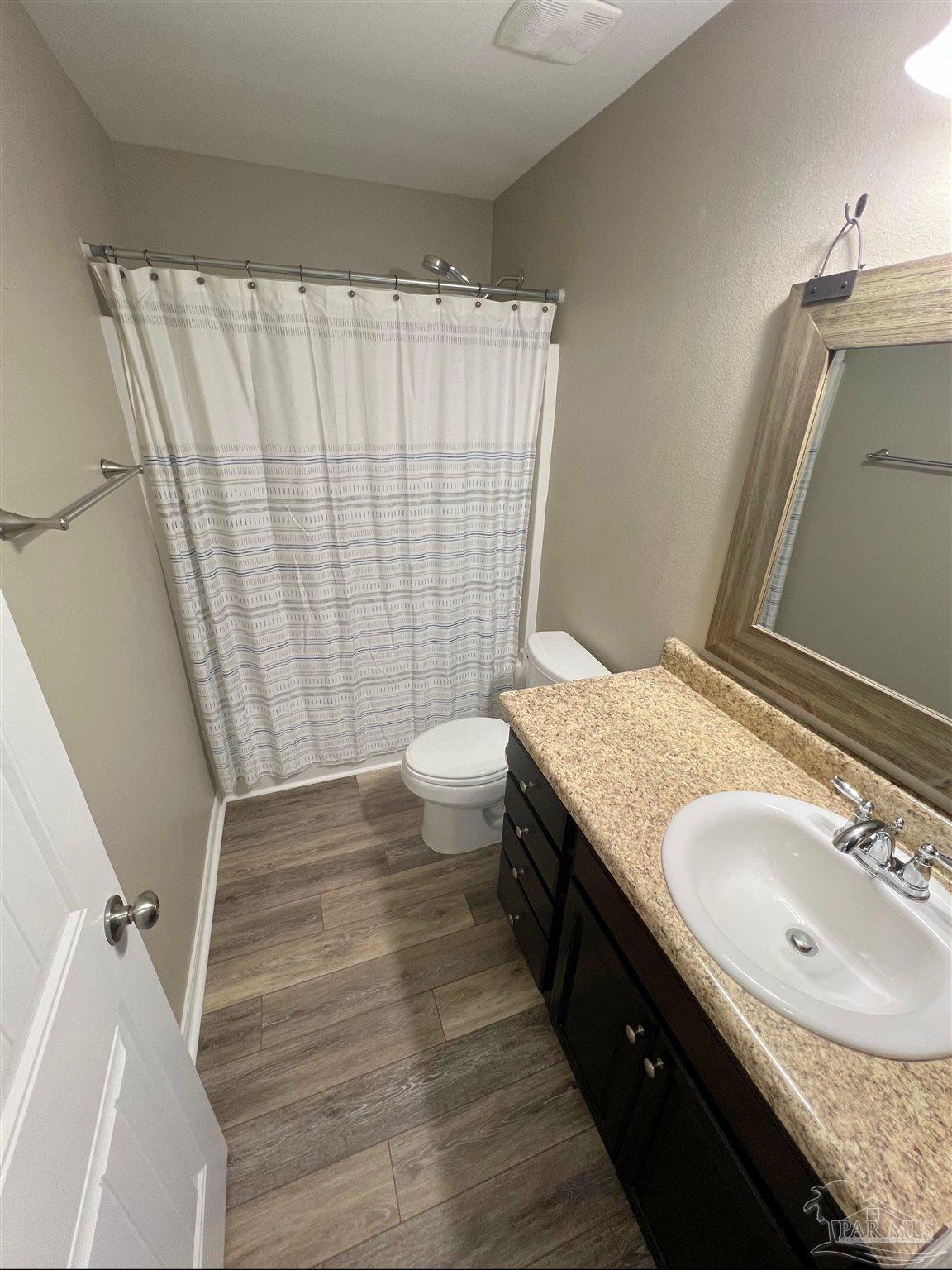 5798 Corkscrew Court Pace, FL 32571 - Photo 13 of 18 a bathroom with a granite countertop sink and a mirror