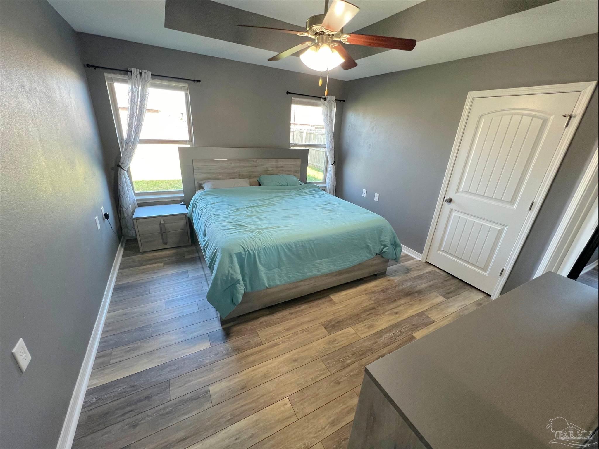 5798 Corkscrew Court Pace, FL 32571 - Photo 7 of 18 a bedroom with a bed and a window