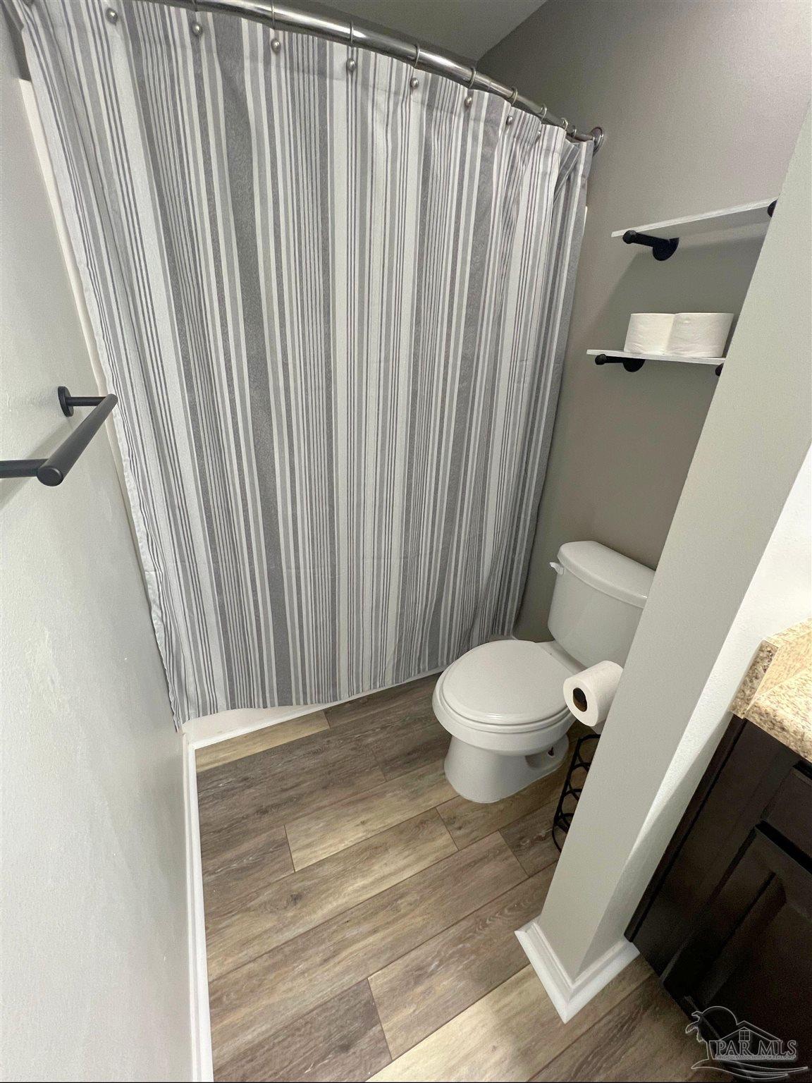 5798 Corkscrew Court Pace, FL 32571 - Photo 9 of 18 a bathroom with a toilet and a shower