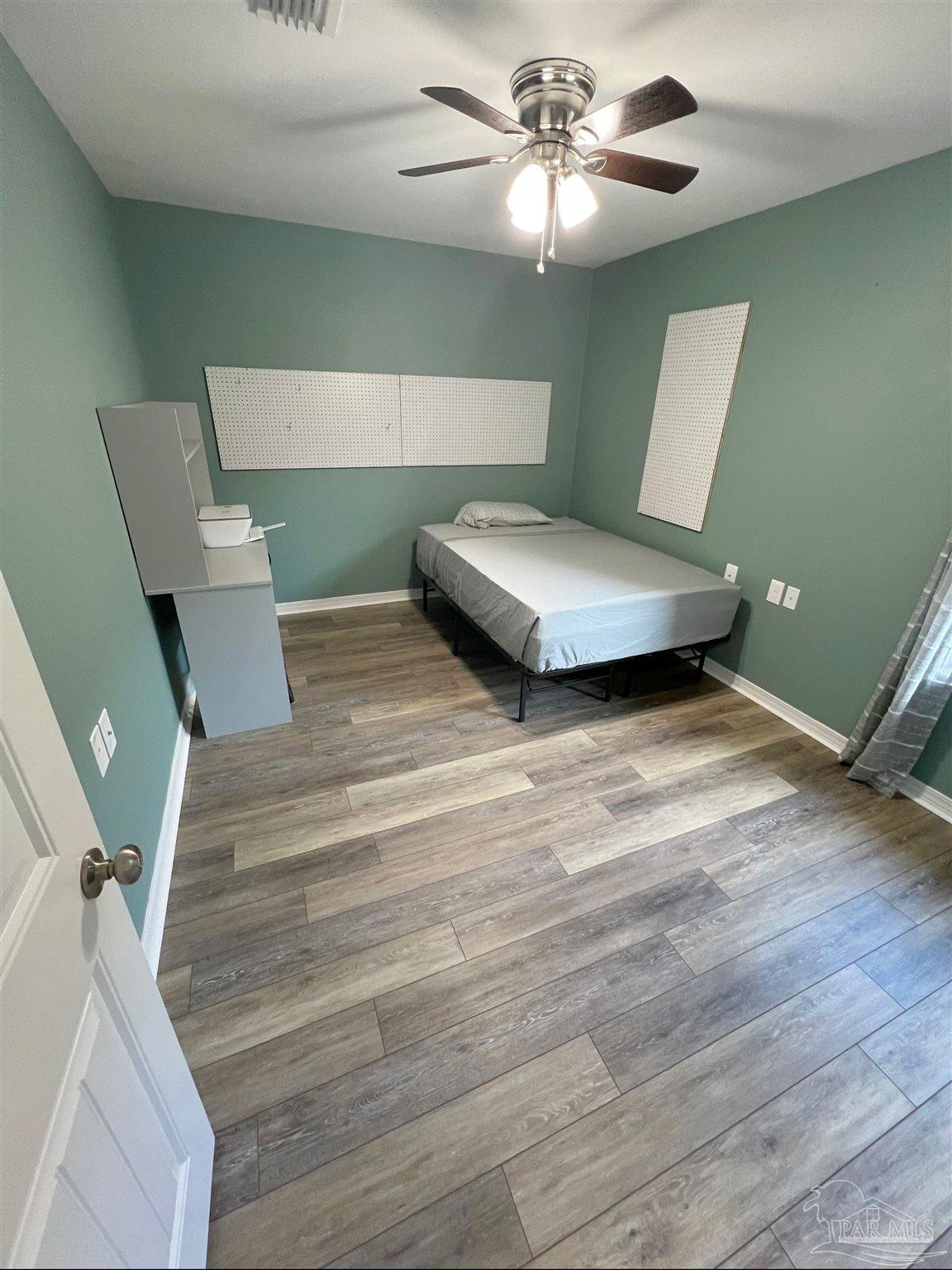 5798 Corkscrew Court Pace, FL 32571 - Photo 10 of 18 a living room with furniture and a ceiling fan