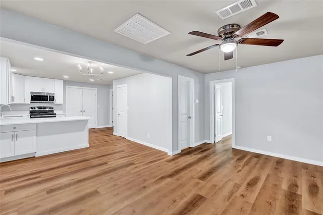 a view of kitchen with sink and wooden floor