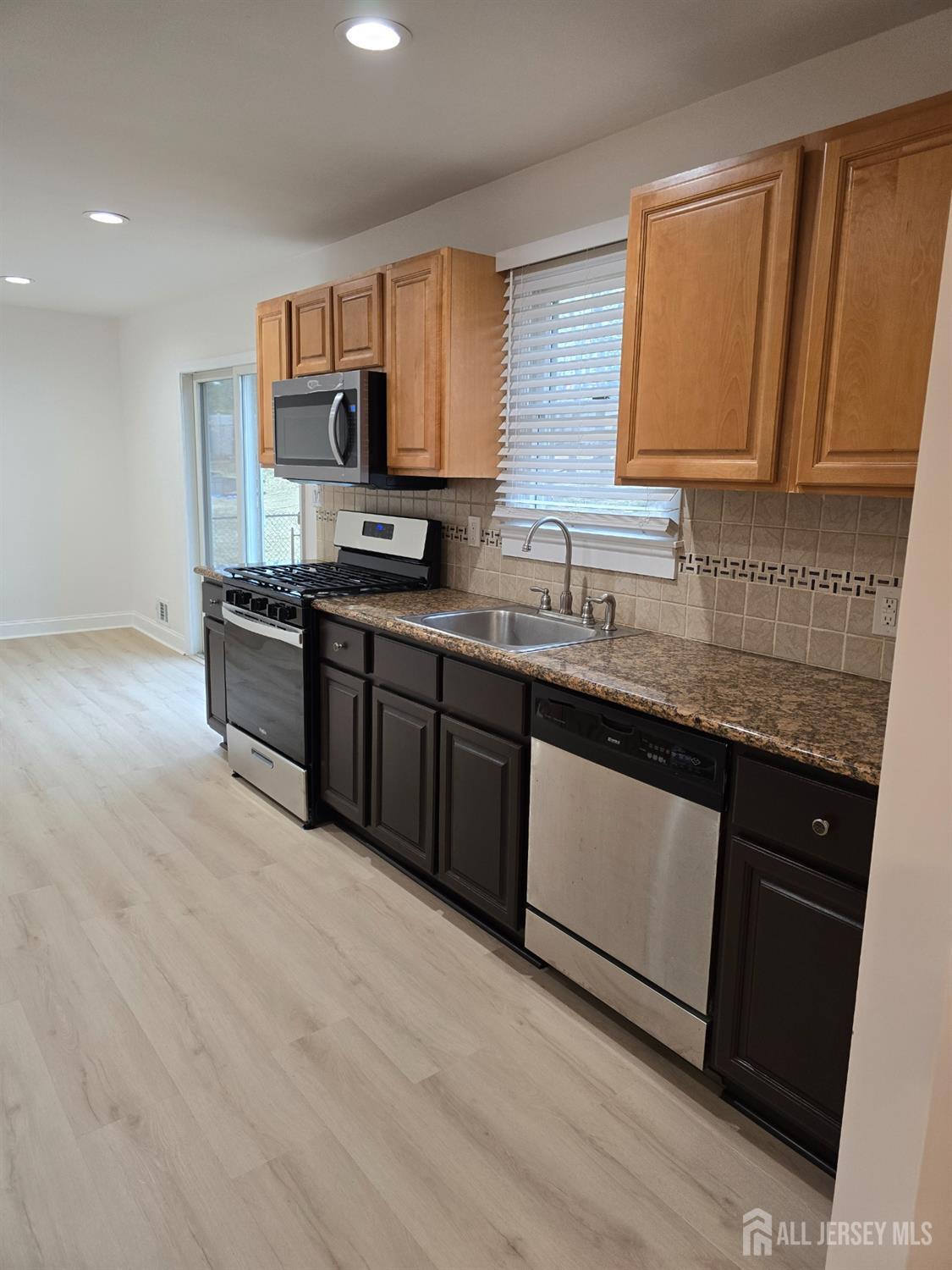 3 Stanley Road East Brunswick, NJ 08816 - Photo 2 of 11 a kitchen with stainless steel appliances granite countertop a sink stove and cabinets