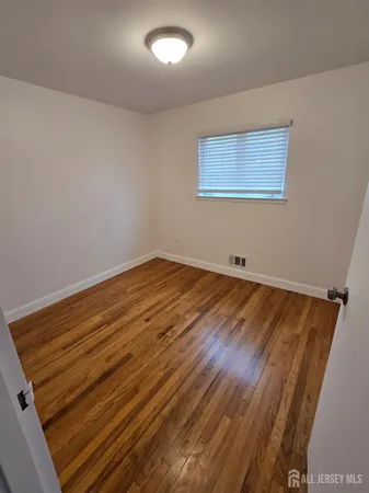 a view of room with wooden floor and fan