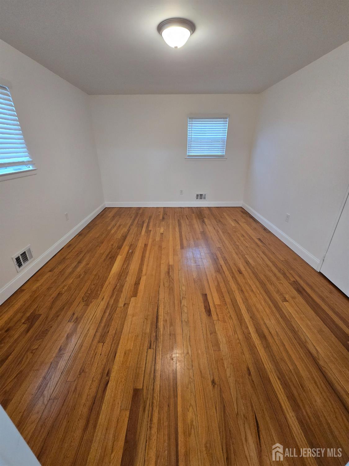 3 Stanley Road East Brunswick, NJ 08816 - Photo 8 of 11 a view of wooden floor in a room