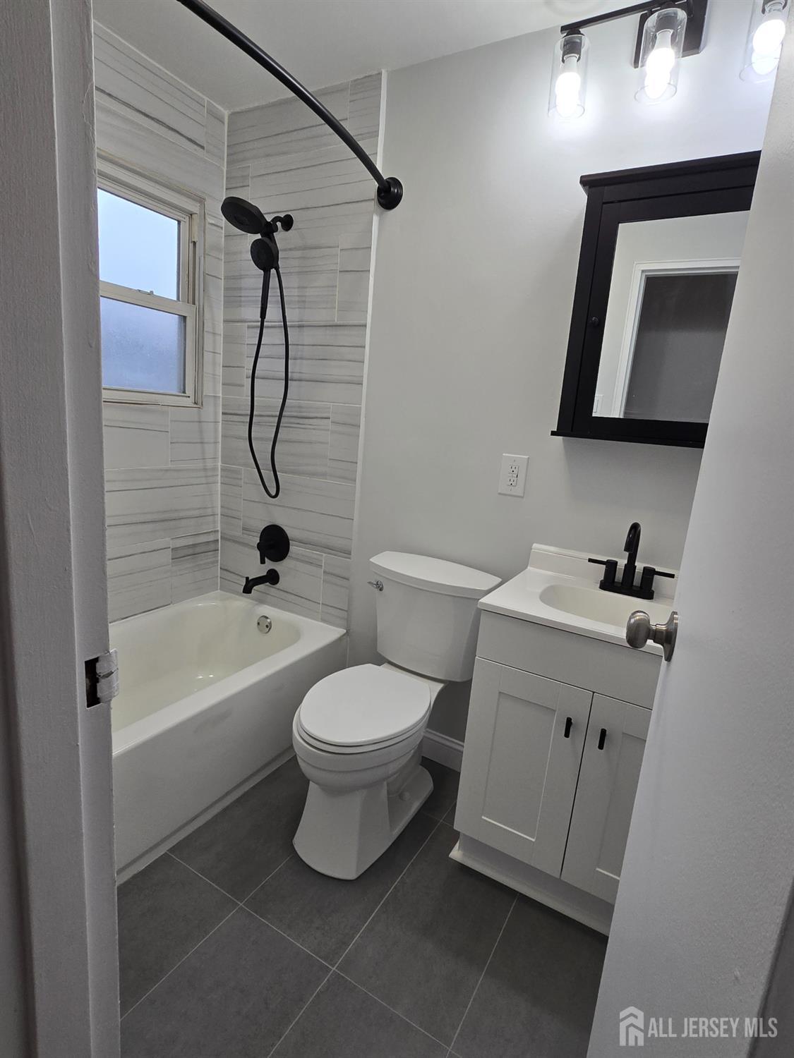 3 Stanley Road East Brunswick, NJ 08816 - Photo 9 of 11 a bathroom with a toilet sink vanity tub and shower