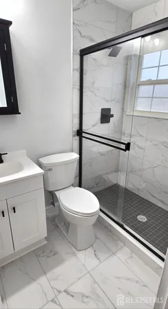 a white toilet sitting next to a bathroom sink