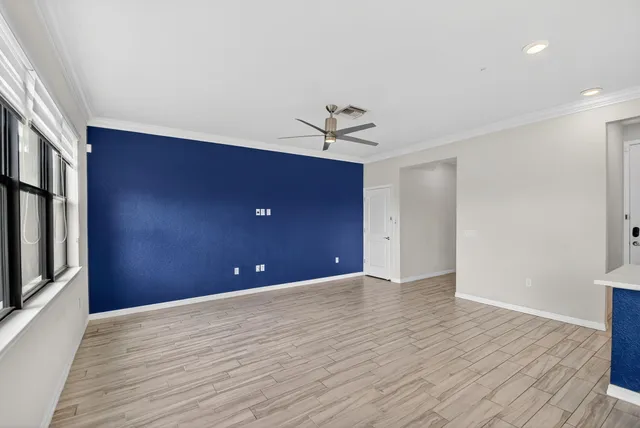 a kitchen with stainless steel appliances kitchen island granite countertop a sink dishwasher a stove and a refrigerator with wooden floor