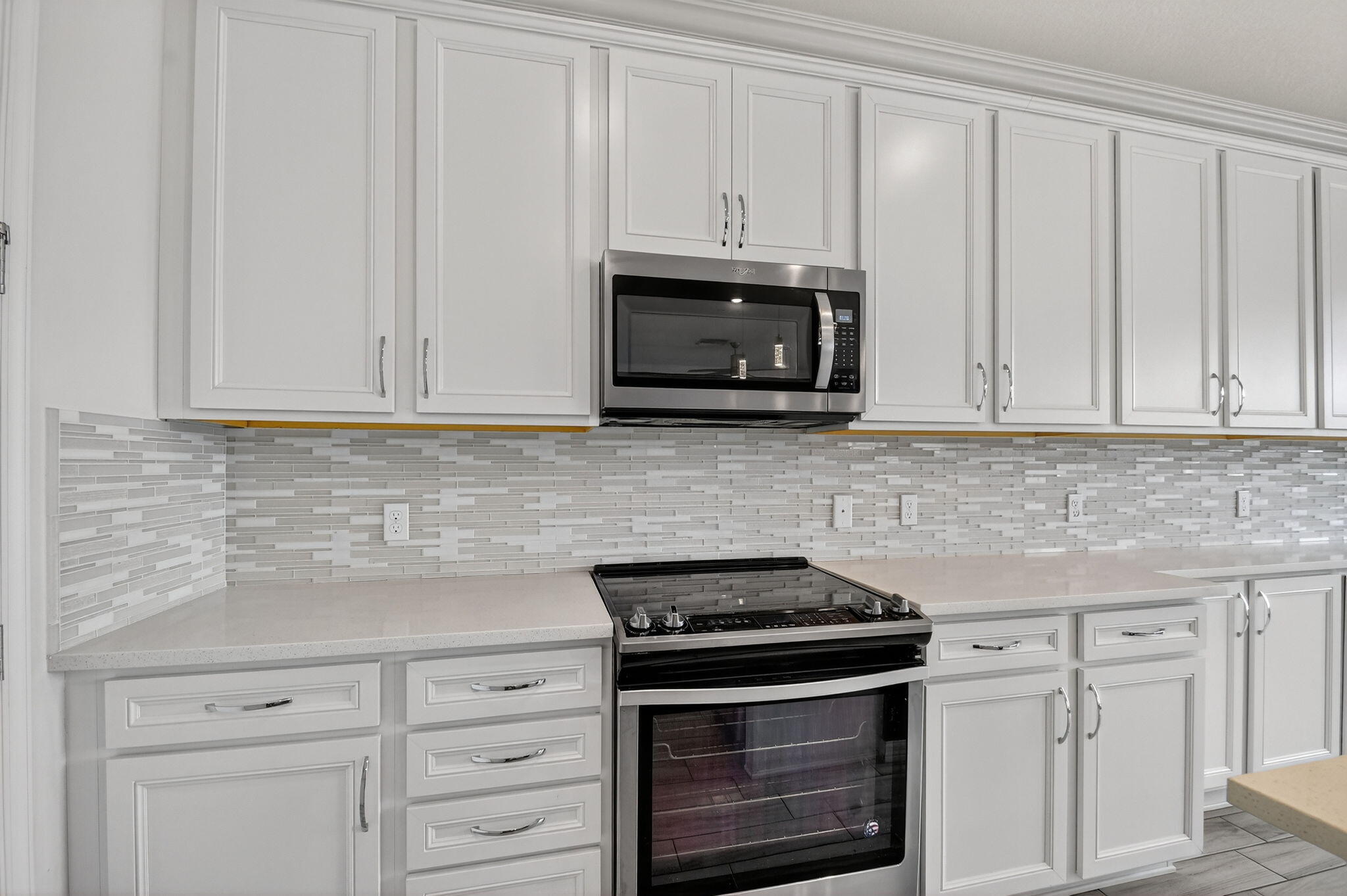 8301 Rearing Lane Lake Worth, FL 33467 - Photo 15 of 109 a kitchen with white cabinets and stainless steel appliances