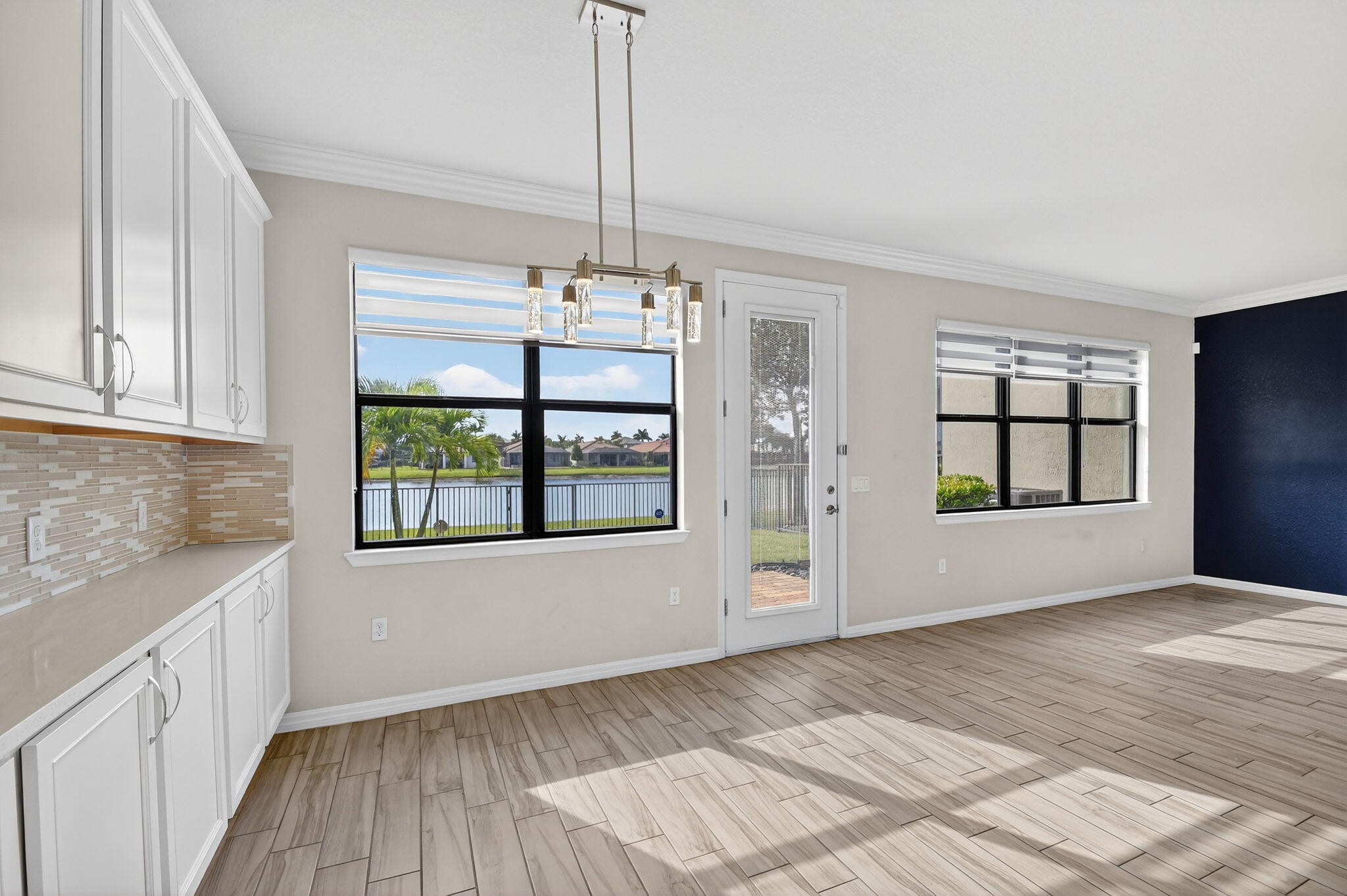 8301 Rearing Lane Lake Worth, FL 33467 - Photo 19 of 109 a view of an empty room with a window and wooden floor