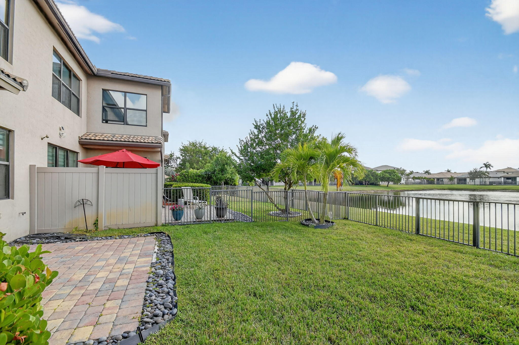 8301 Rearing Lane Lake Worth, FL 33467 - Photo 48 of 109 a backyard of a house with table and chairs
