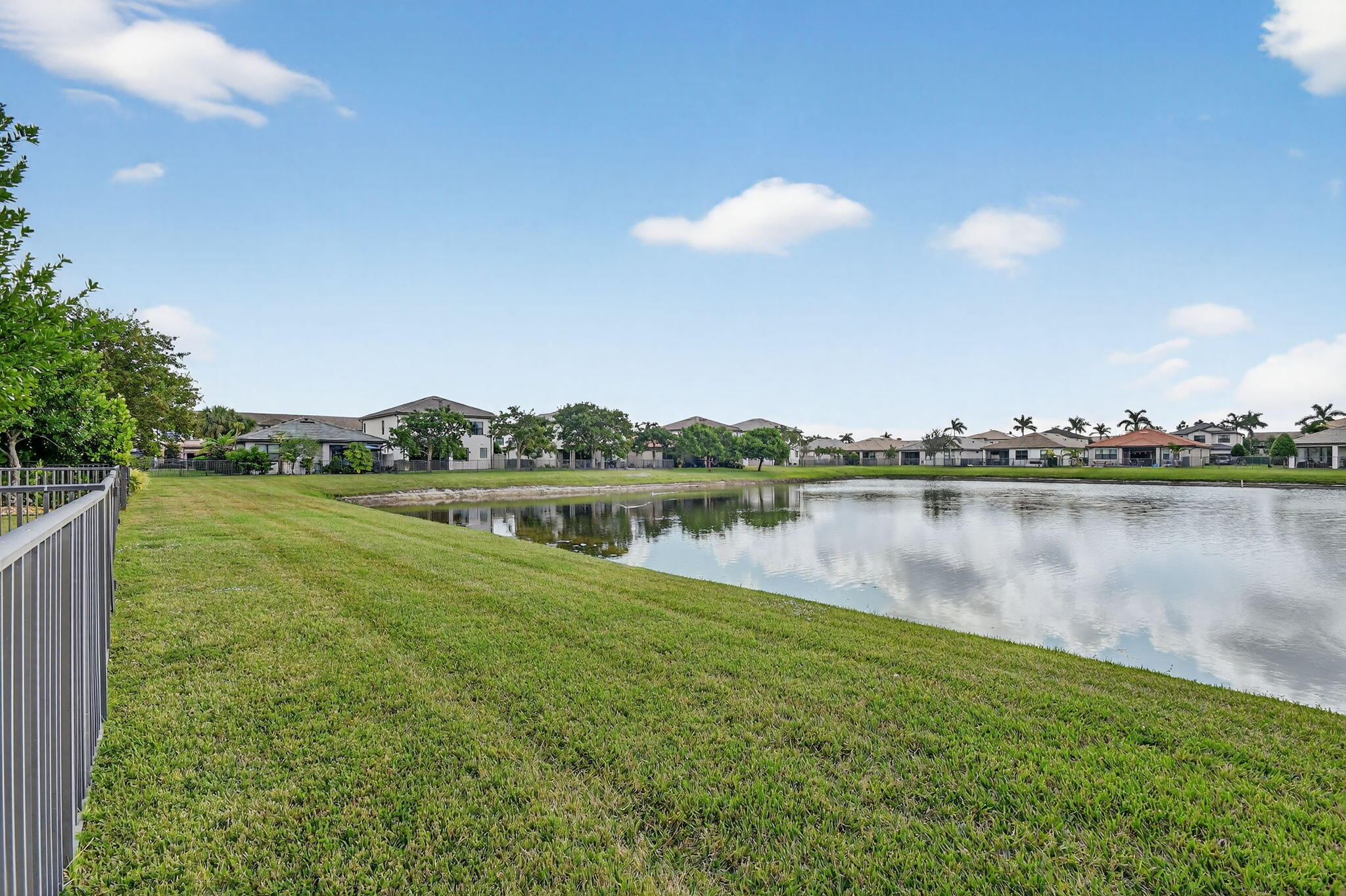 8301 Rearing Lane Lake Worth, FL 33467 - Photo 50 of 109 a view of a lake with houses in the back