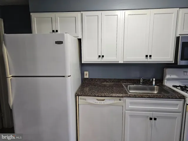 a white refrigerator freezer sitting inside of a kitchen