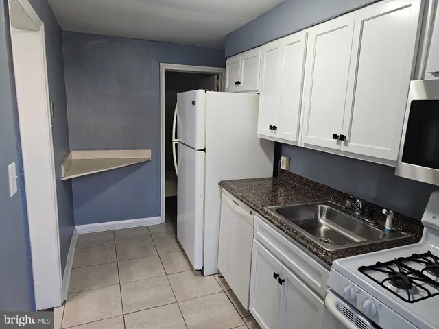 a kitchen with a stove and a refrigerator