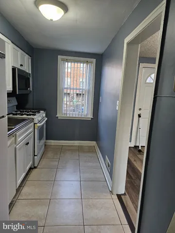 a kitchen with a stove a microwave and a sink