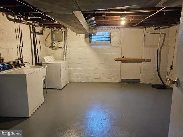 a view of storage and utility room with washer and dryer
