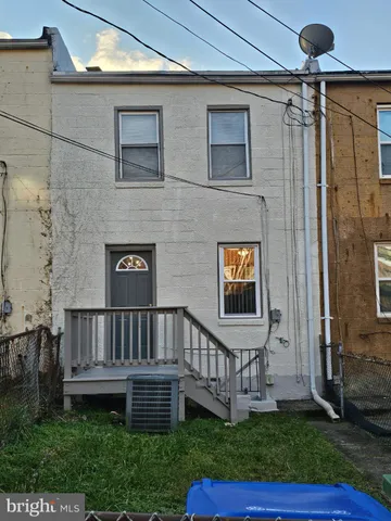 a view of a house with a yard and deck