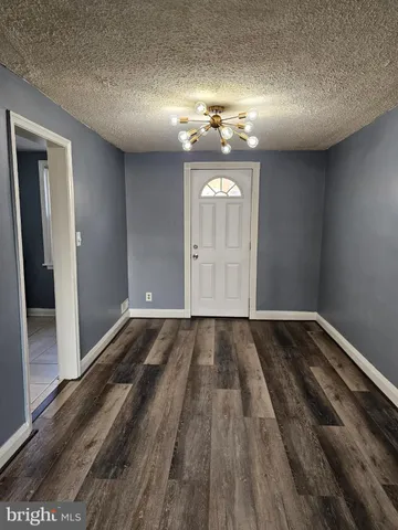 a view of an empty room and wooden floor