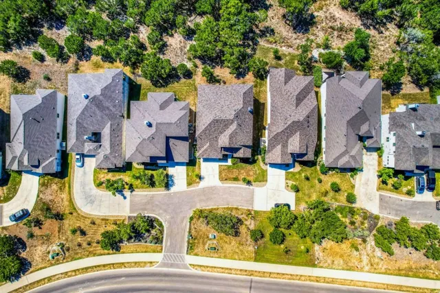 an aerial view of residential houses with yard and swimming pool