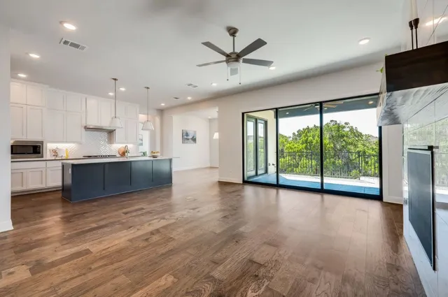 a view of kitchen with refrigerator and wooden floor