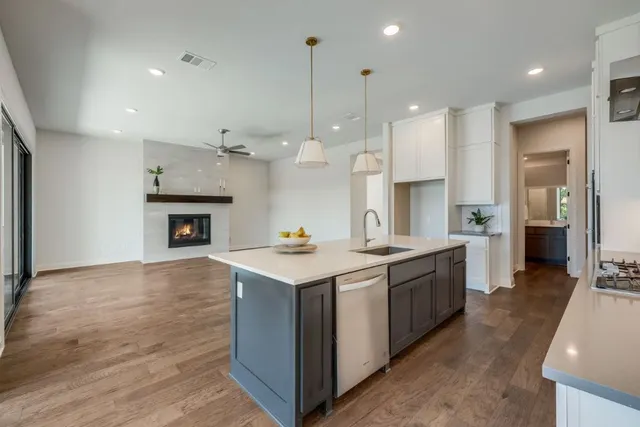 a kitchen with kitchen island a sink stainless steel appliances and cabinets