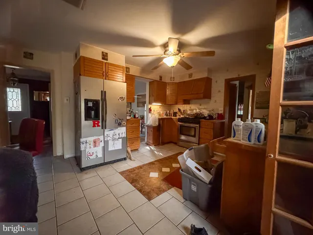 a living room with couches and kitchen view