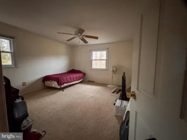 a bedroom with bed and a window