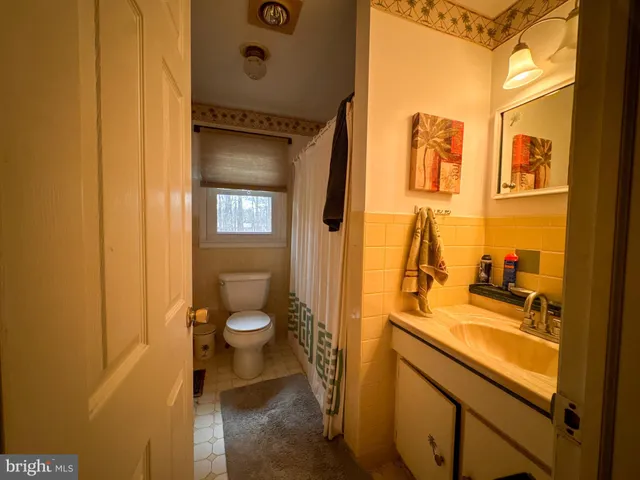 a bed room with a bed and a ceiling fan