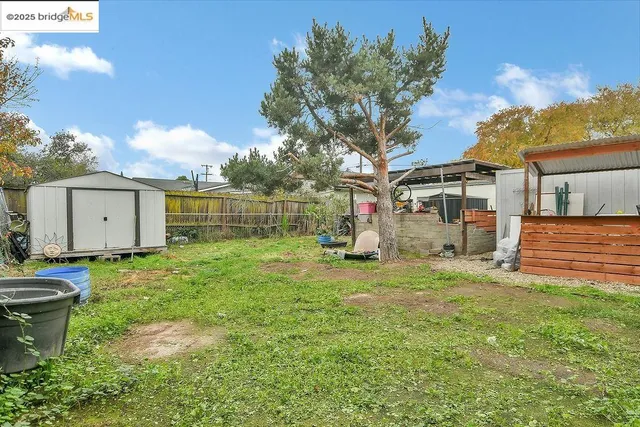 a view of a backyard with a garden and entertaining space
