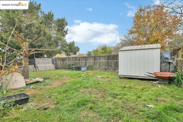 an aerial view of a residential houses with yard
