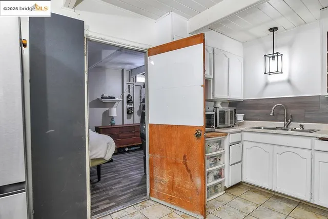 a room with a sink and a wooden cabinets