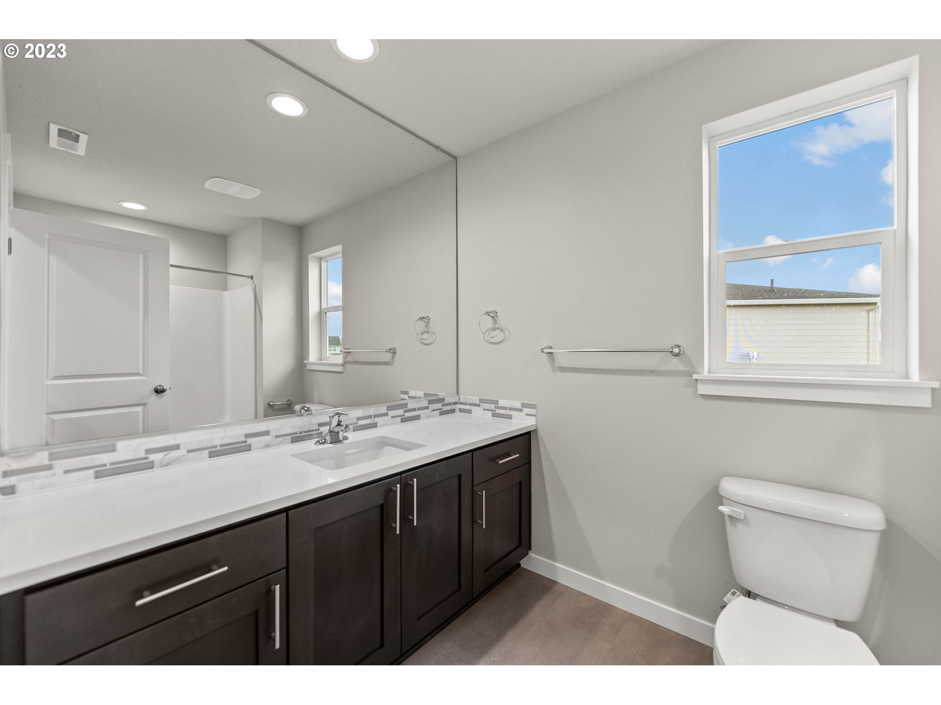 8823 North 3rd Circle Ridgefield, WA 98642 - Photo 25 of 41 a bathroom with a sink a toilet and a mirror