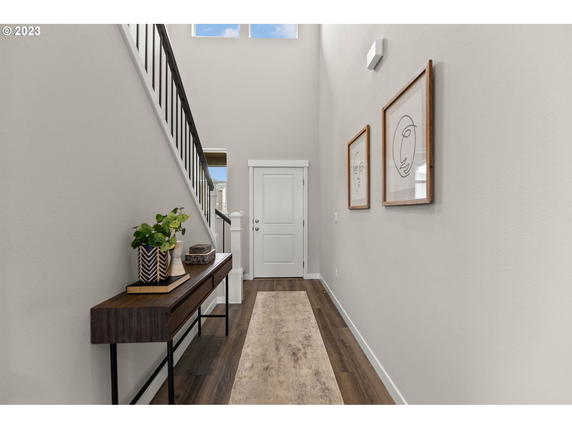 8823 North 3rd Circle Ridgefield, WA 98642 - Photo 4 of 41 a hallway with table and stairs