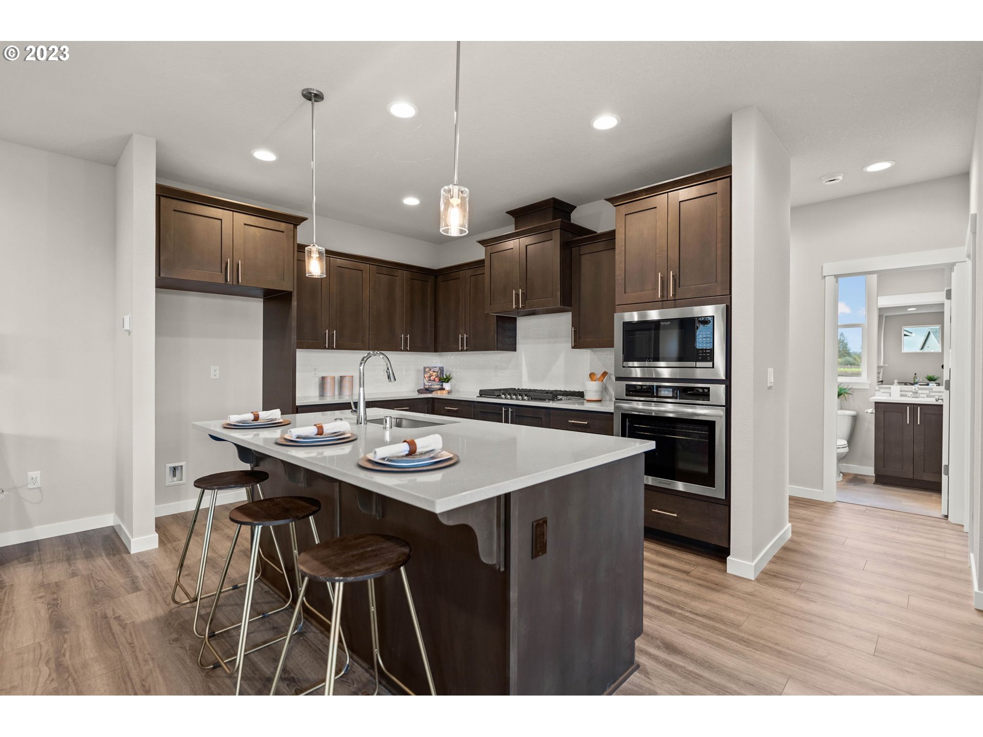 8823 North 3rd Circle Ridgefield, WA 98642 - Photo 6 of 41 a kitchen with kitchen island stainless steel appliances a sink and a refrigerator