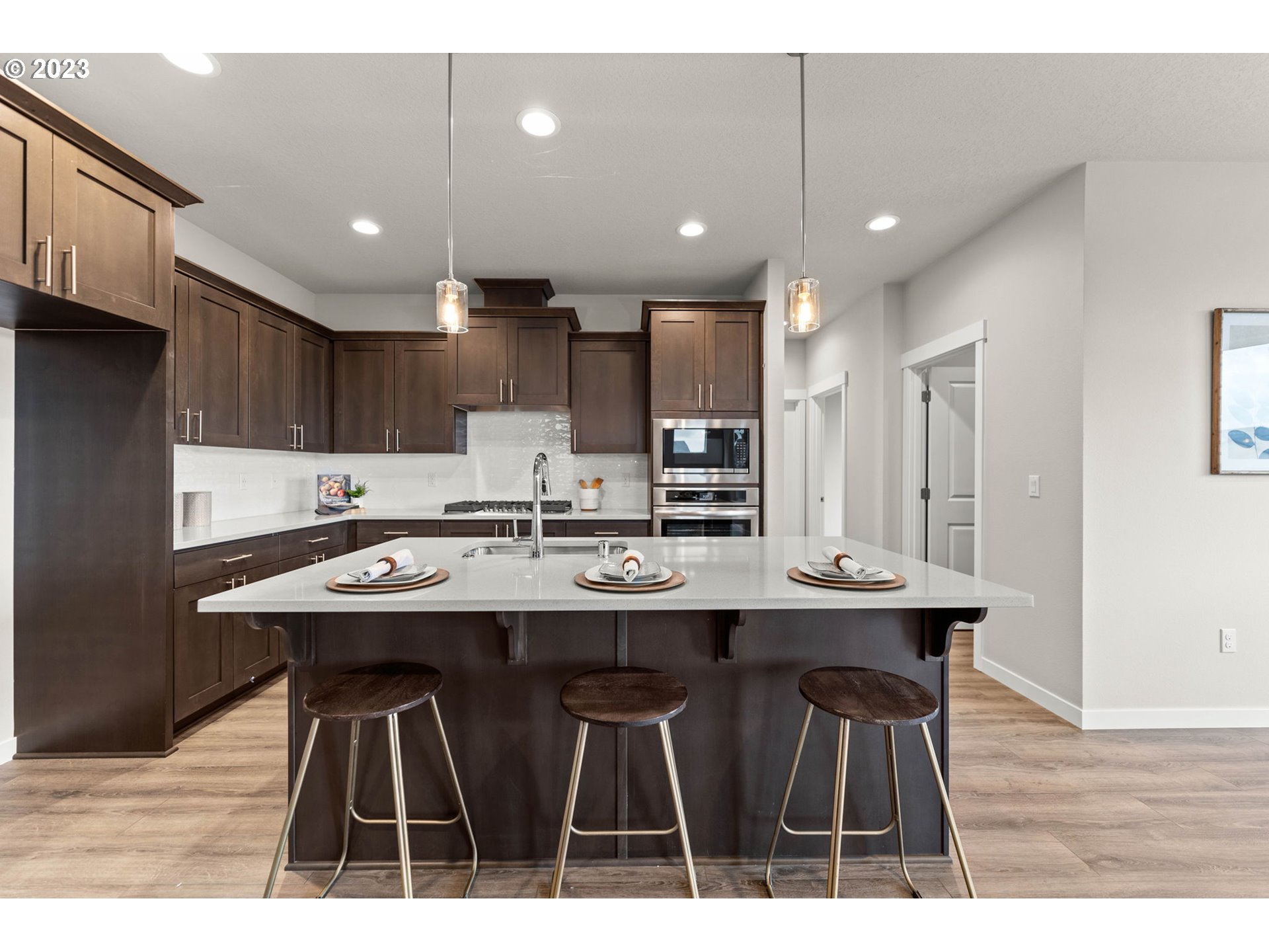 8823 North 3rd Circle Ridgefield, WA 98642 - Photo 7 of 41 a kitchen with kitchen island a sink table and chairs