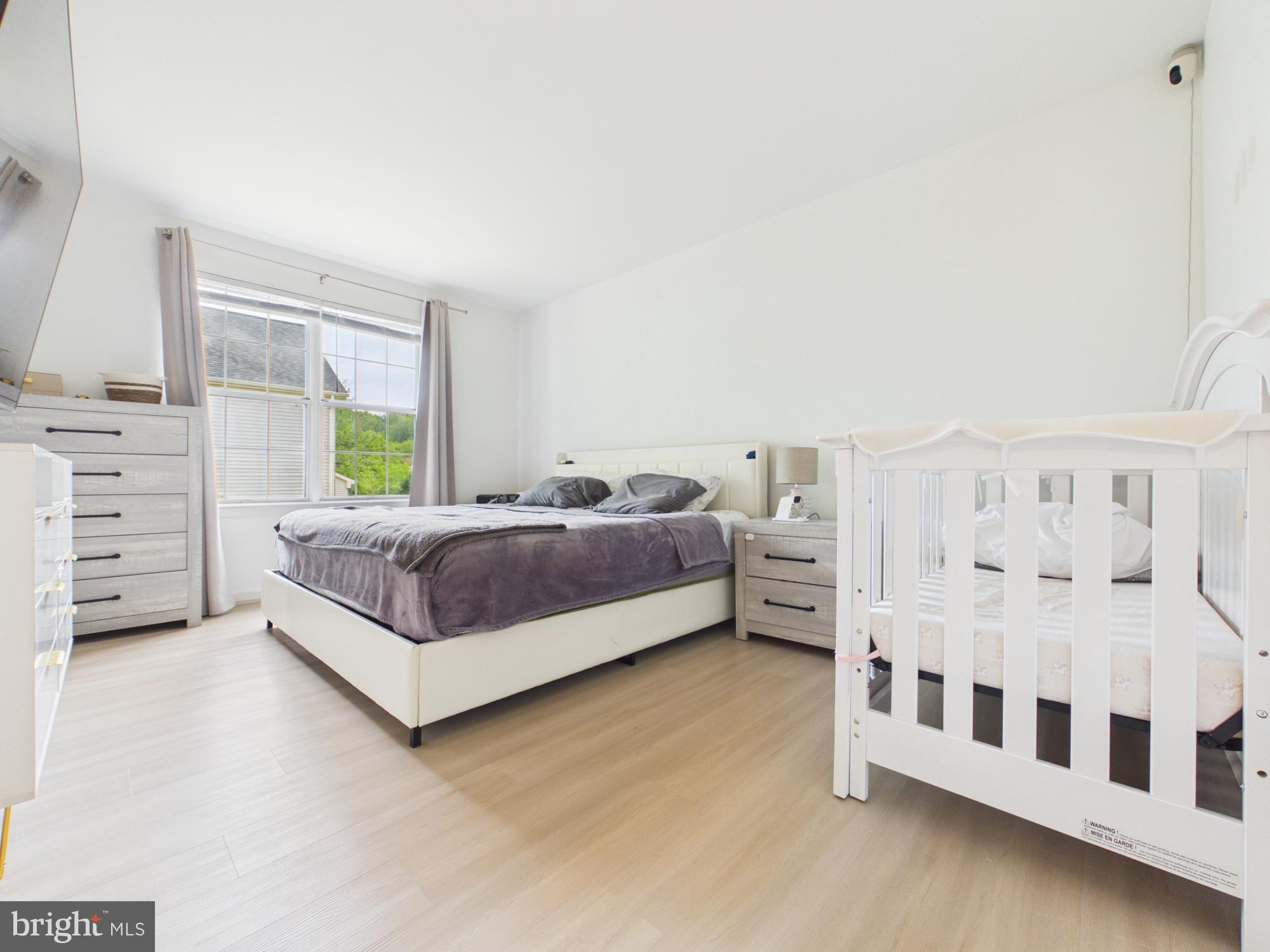 7606 Huntsman Court Clinton, MD 20735 - Photo 24 of 40 a bedroom with a bed and a window