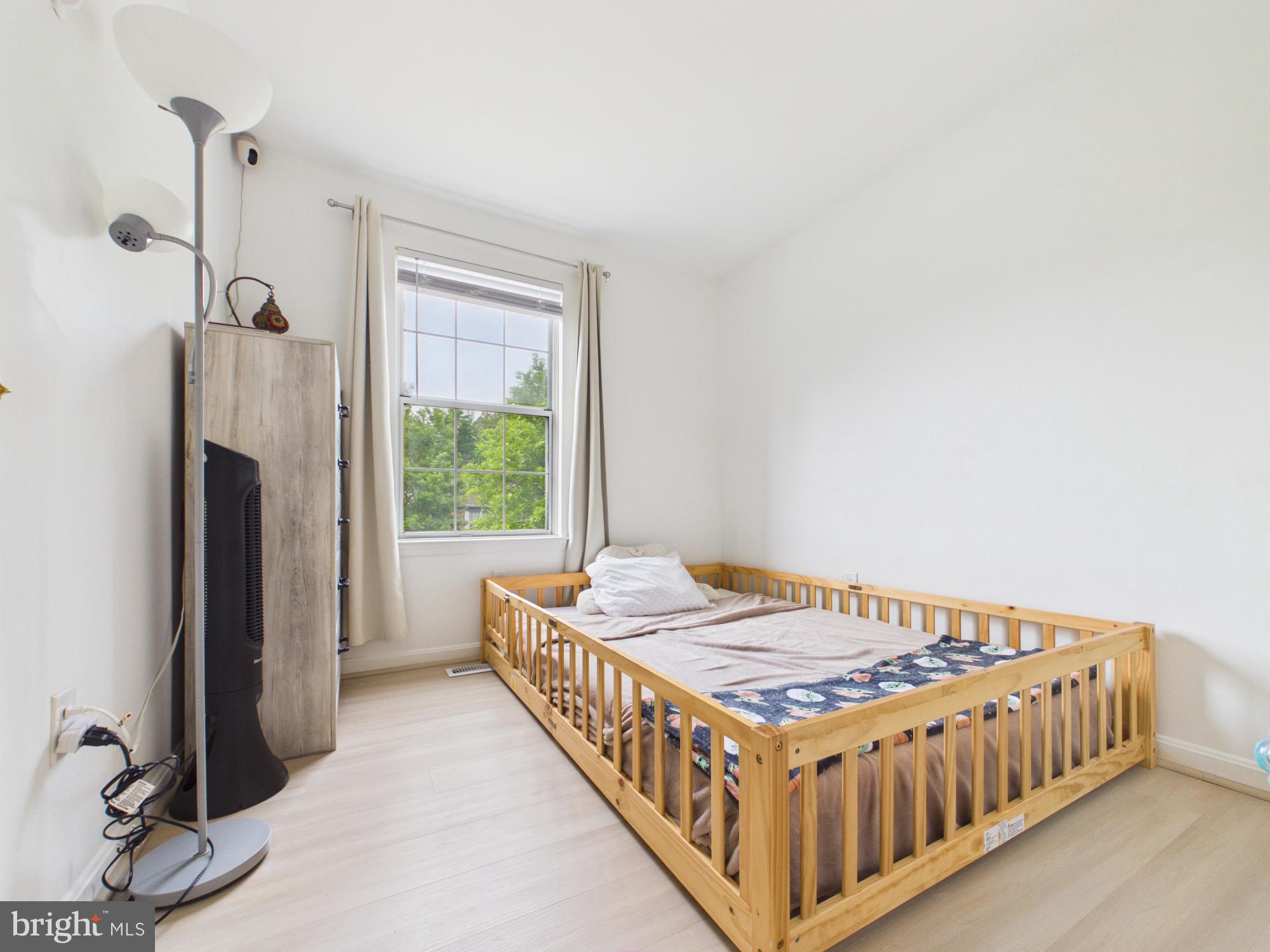 7606 Huntsman Court Clinton, MD 20735 - Photo 25 of 40 a bed sitting in a bedroom next to a window