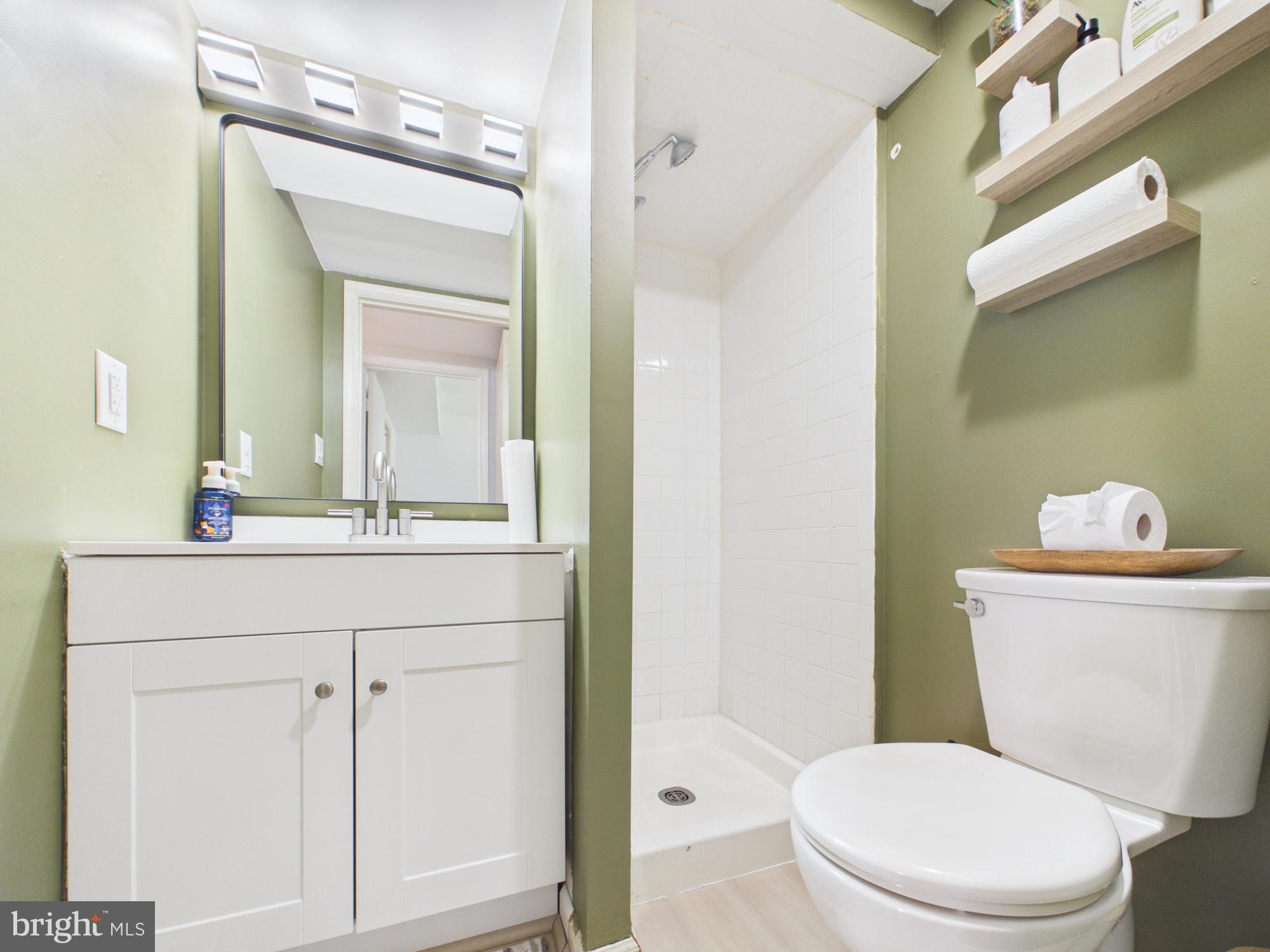 7606 Huntsman Court Clinton, MD 20735 - Photo 29 of 40 a bathroom with a sink vanity mirror and toilet