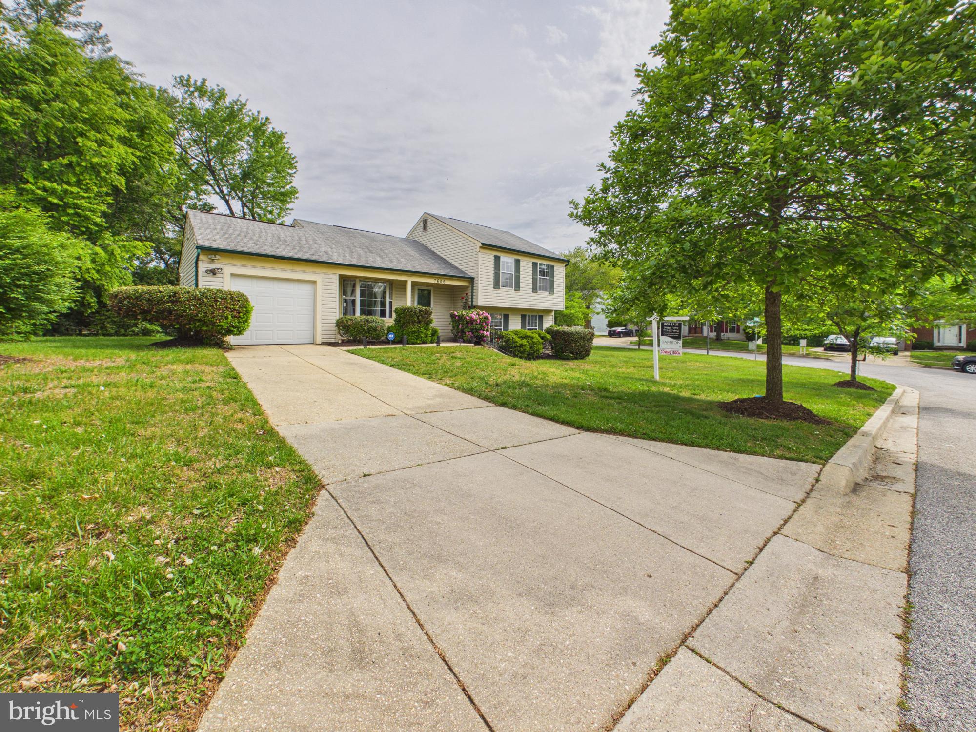 7606 Huntsman Court Clinton, MD 20735 - Photo 3 of 40 a front view of a house with a yard and trees