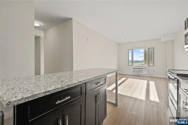 a view of a kitchen island wooden floor and living room