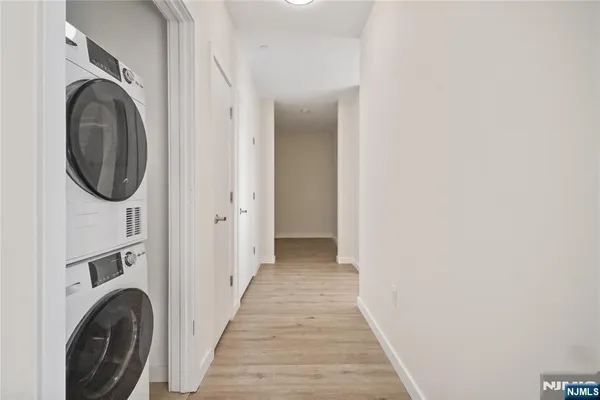 a view of a hallway with washer and dryer