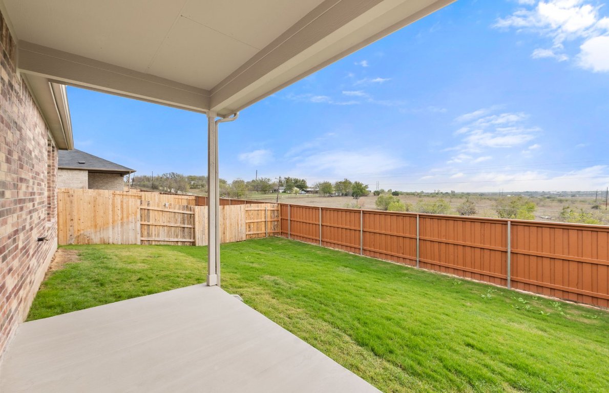 482 Kapok Street Buda, TX 78610 - Photo 19 of 22 a view of a backyard with wooden fence