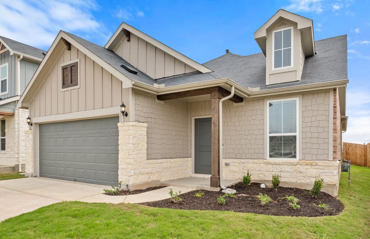 482 Kapok Street Buda, TX 78610 - Photo 2 of 22 a front view of a house with a yard