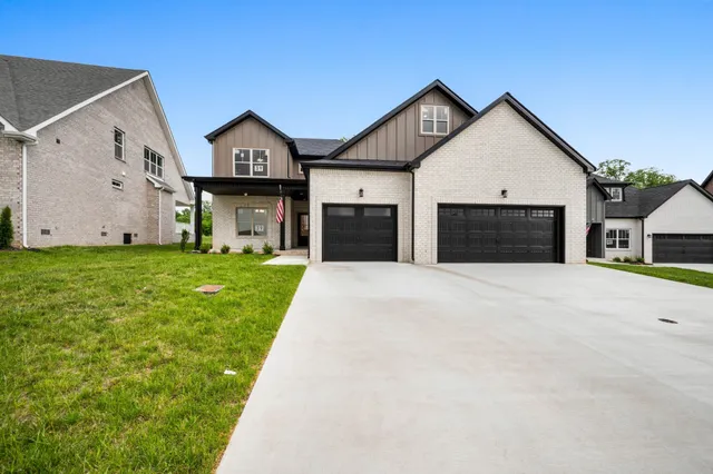 a front view of a house with yard and garage