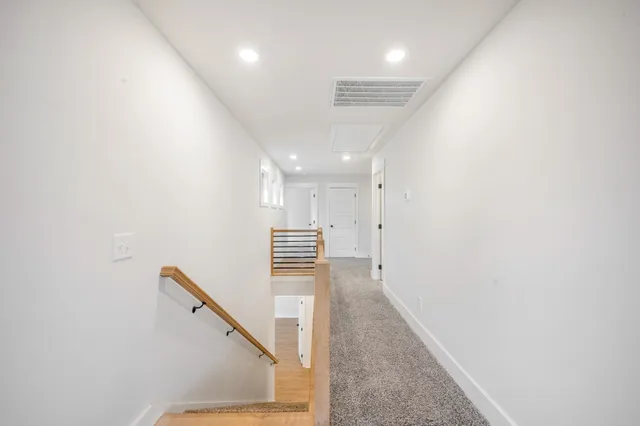 an empty room with ceiling fan and window