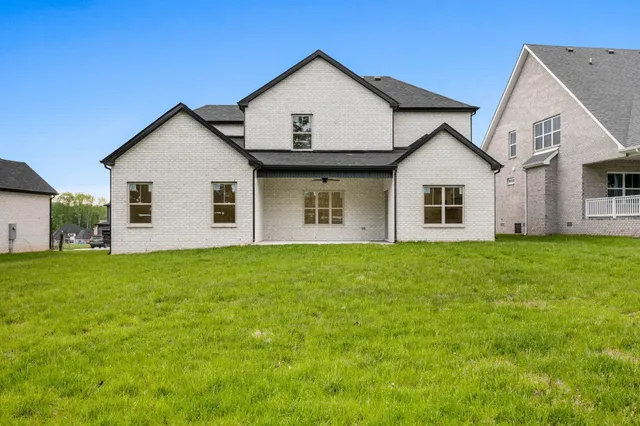 a view of a house with a yard and garage