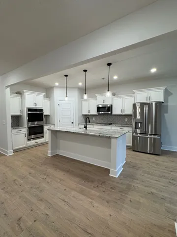 a large kitchen with stainless steel appliances kitchen island granite countertop a large counter top stainless steel appliances and cabinets