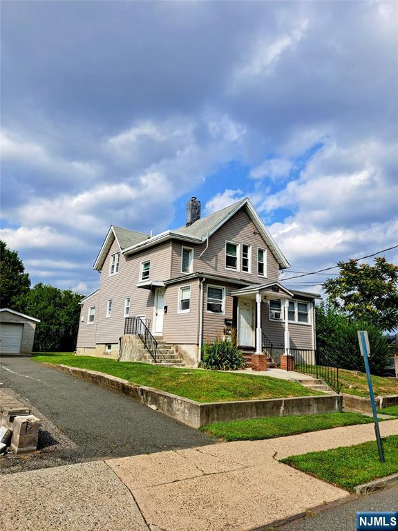 114-116 Myer Street Hackensack, NJ 07601 - Photo 1 of 7 a front view of a house with a yard