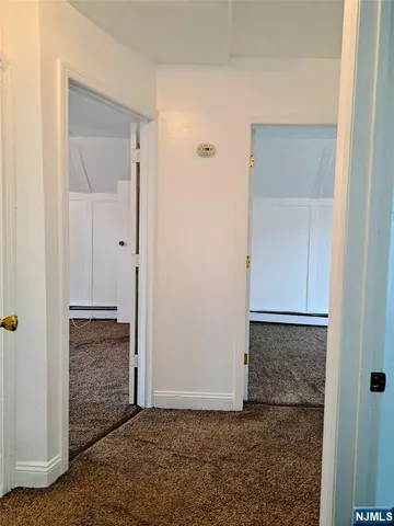 a view of a room with window and a ceiling fan