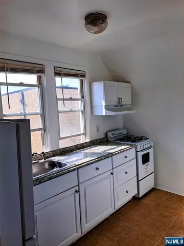 a bathroom with a sink a toilet a window and bathtub