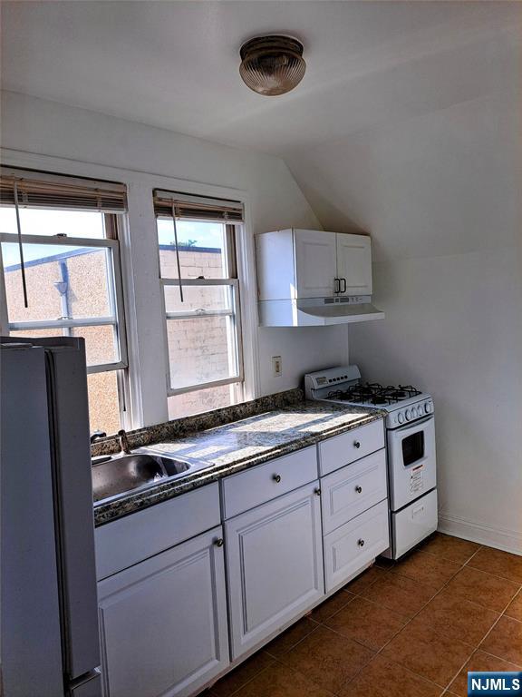 114-116 Myer Street Hackensack, NJ 07601 - Photo 4 of 7 a kitchen with stainless steel appliances granite countertop a sink a stove and a refrigerator